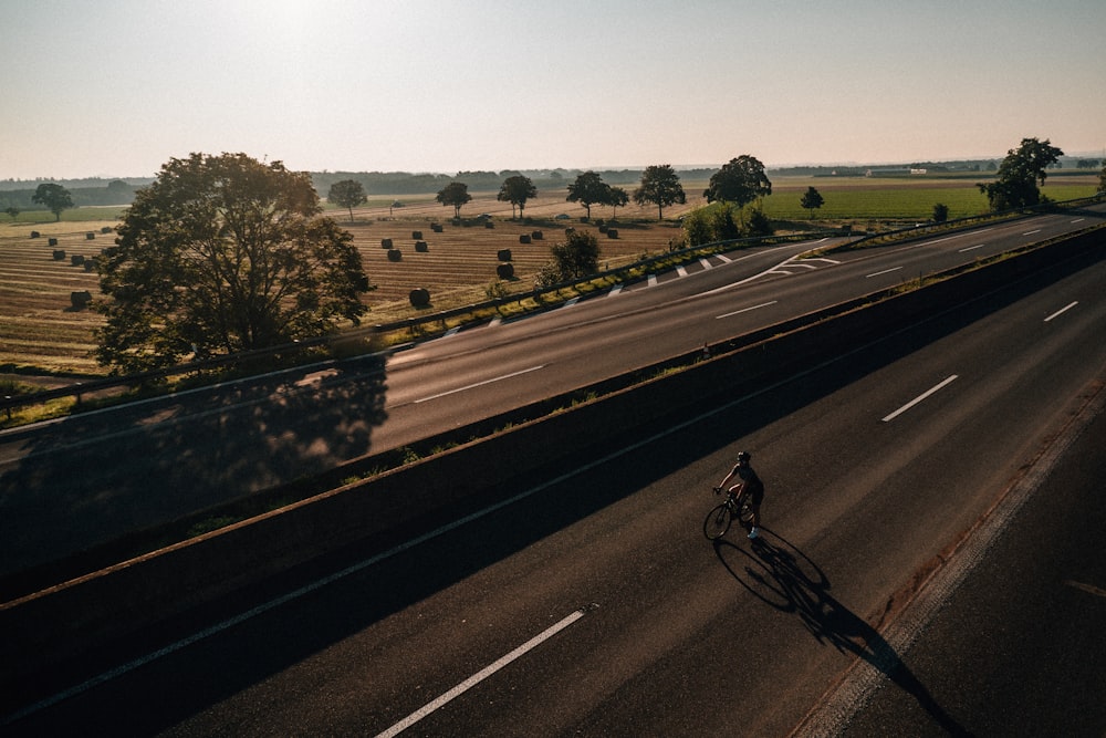 a person riding a bike down a road