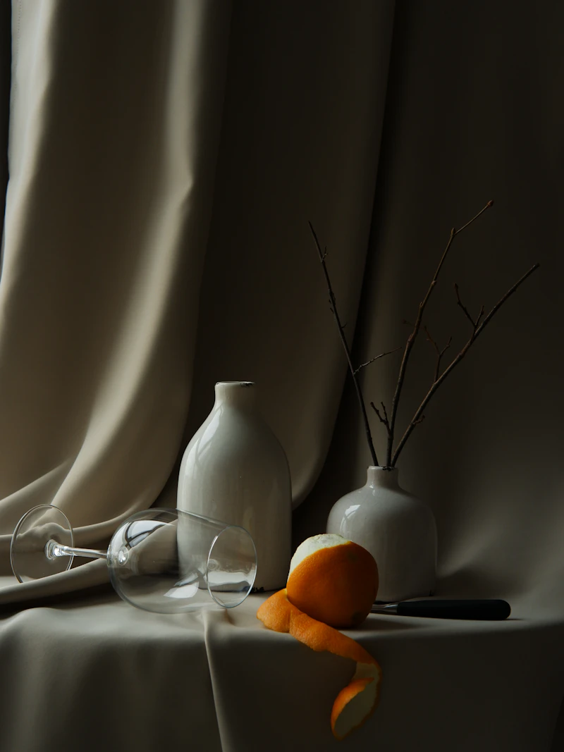 Still life of a white vase on a table