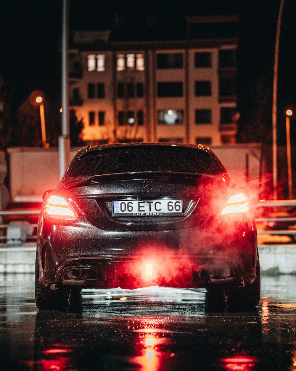 a car driving down a street at night