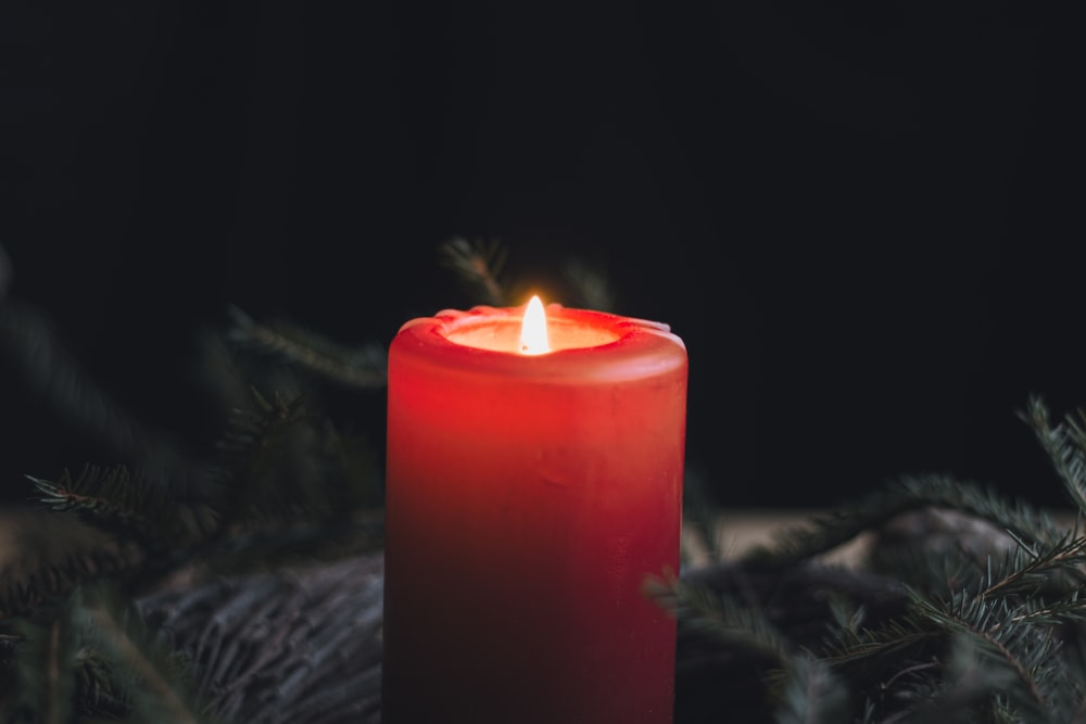 a lit candle sitting on top of a table