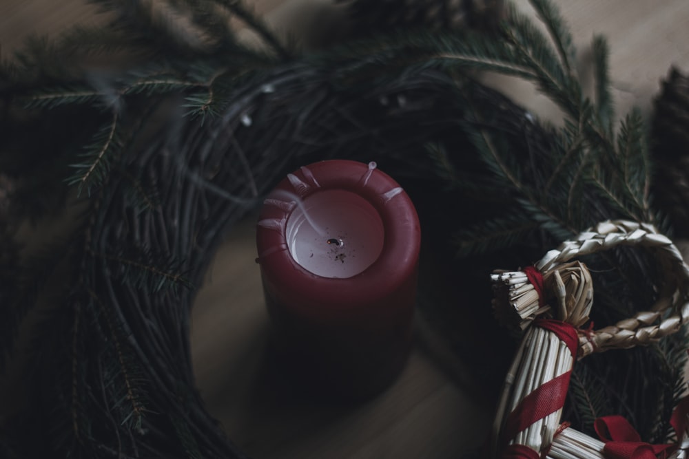 a red candle sitting on top of a wooden table