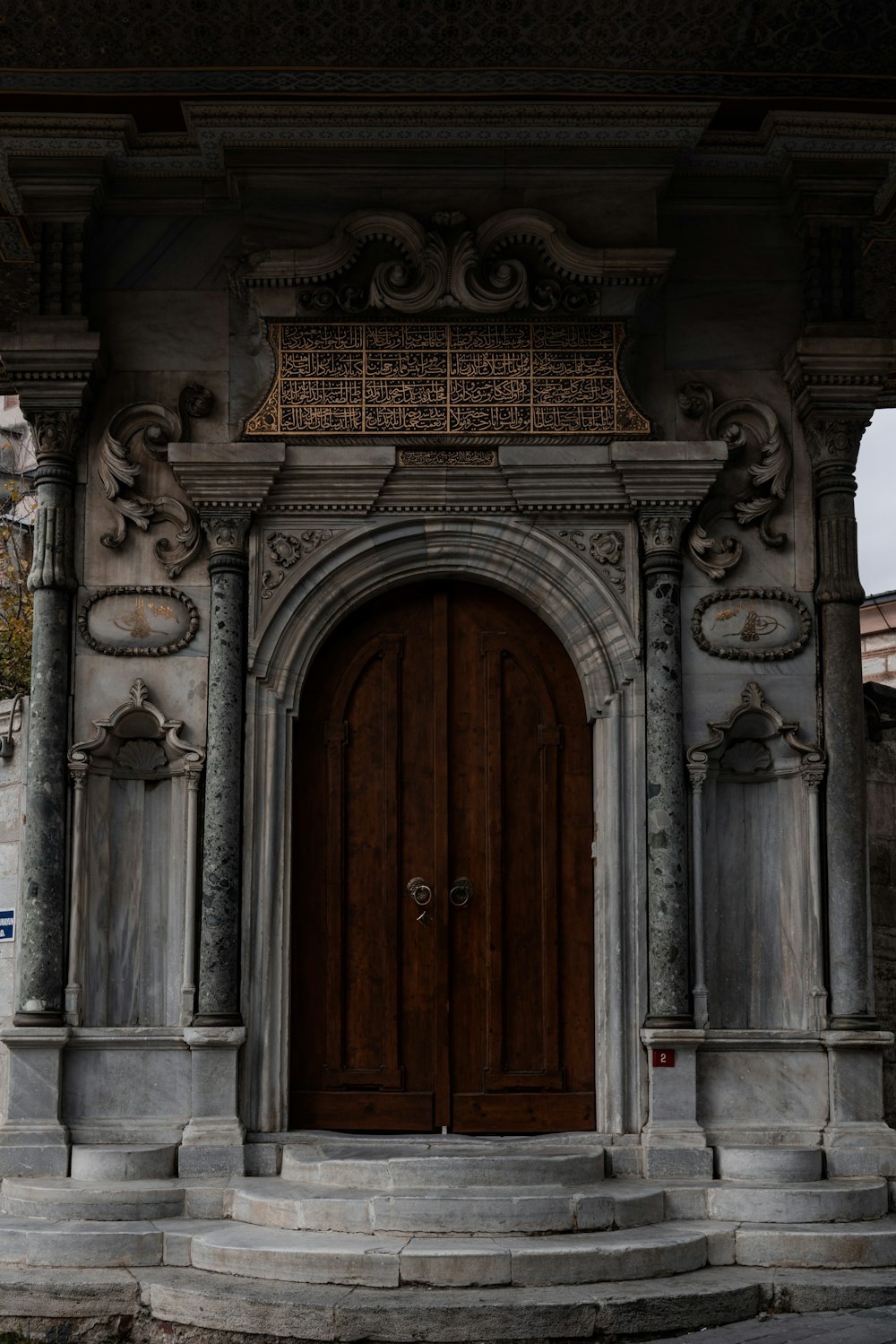 a large wooden door sitting inside of a stone building