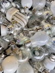 A collection of various LED light bulbs on a shelf.