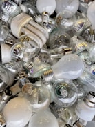 A collection of various LED light bulbs on a shelf.