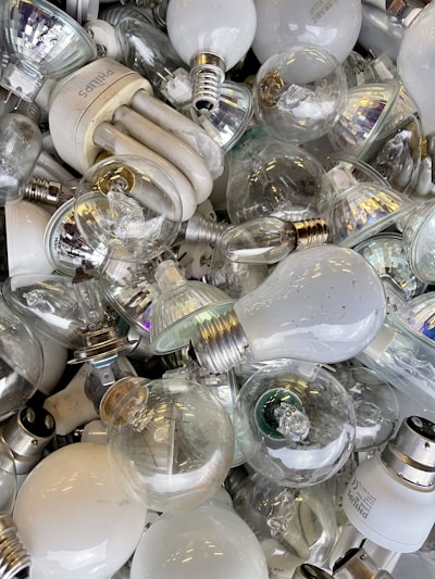 A bright assortment of various light bulbs displayed on a shelf.