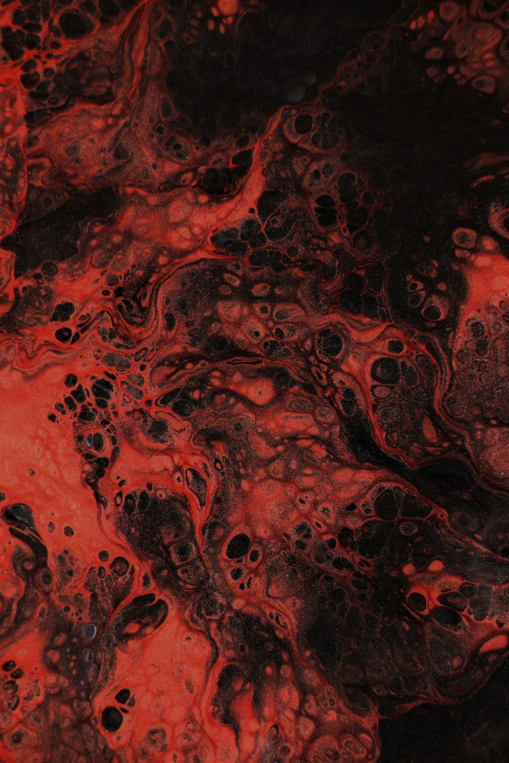 a close up of a red and black substance