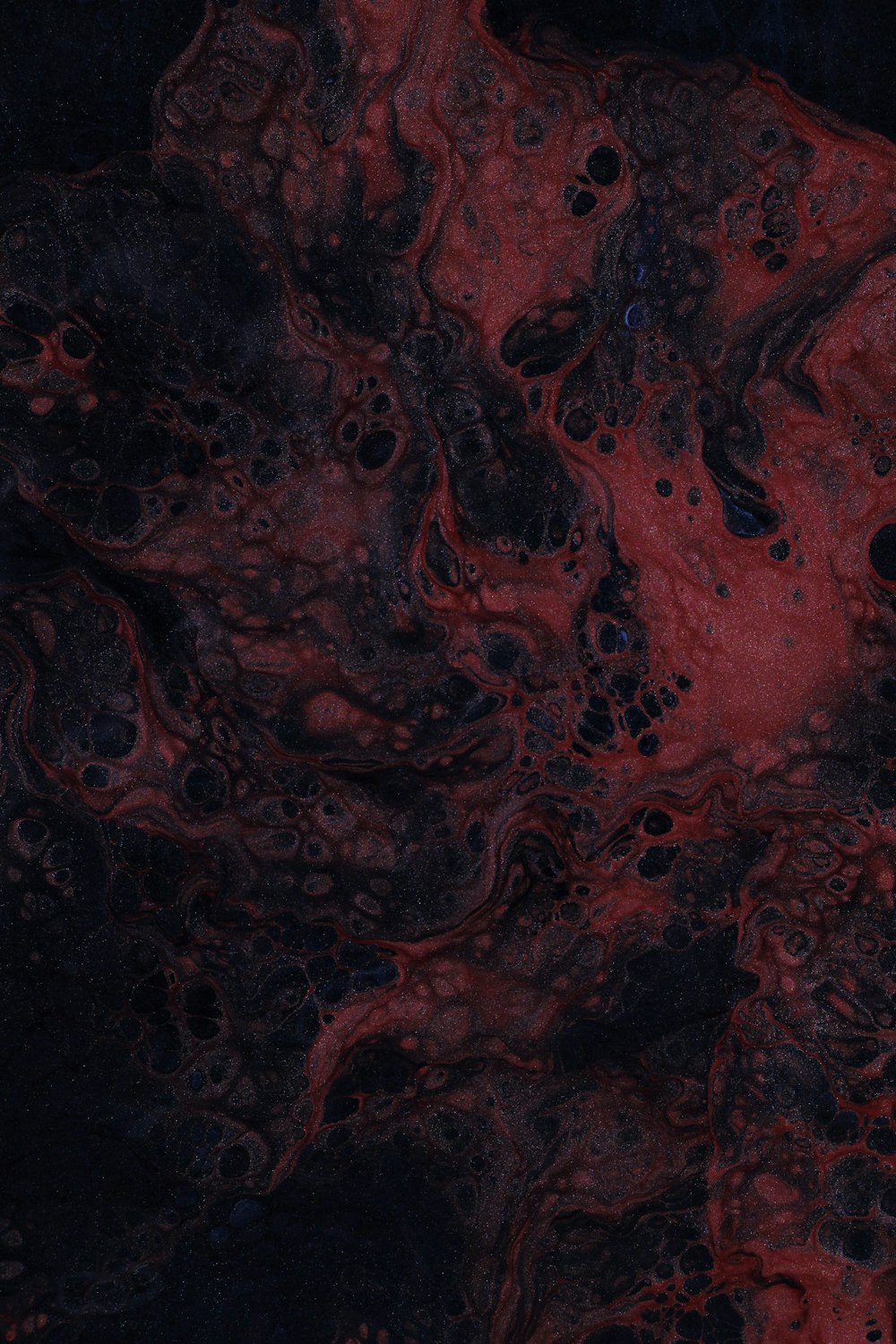 a close up of a red and black substance