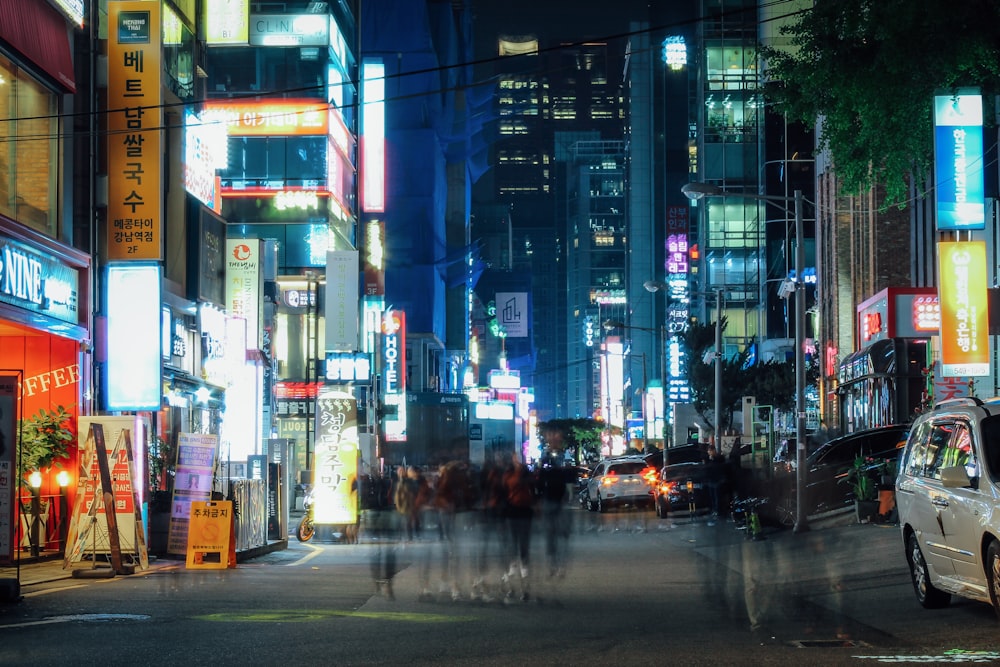 a busy city street at night with neon lights