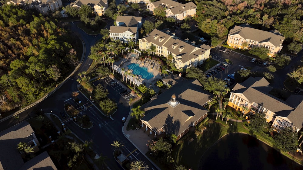 a bird's eye view of a neighborhood with a swimming pool