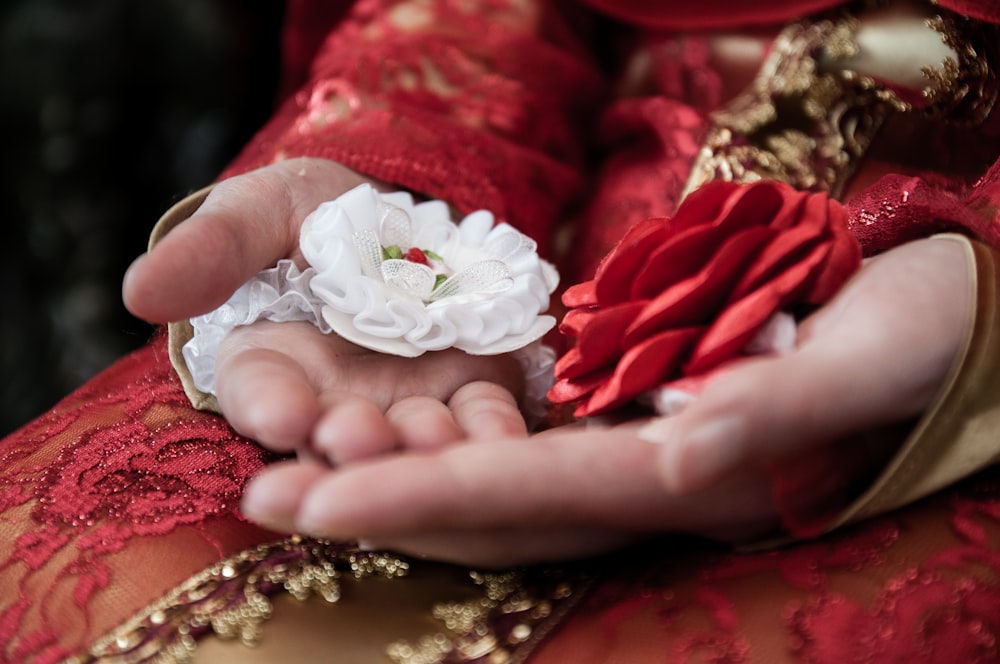 a person holding a flower in their hands