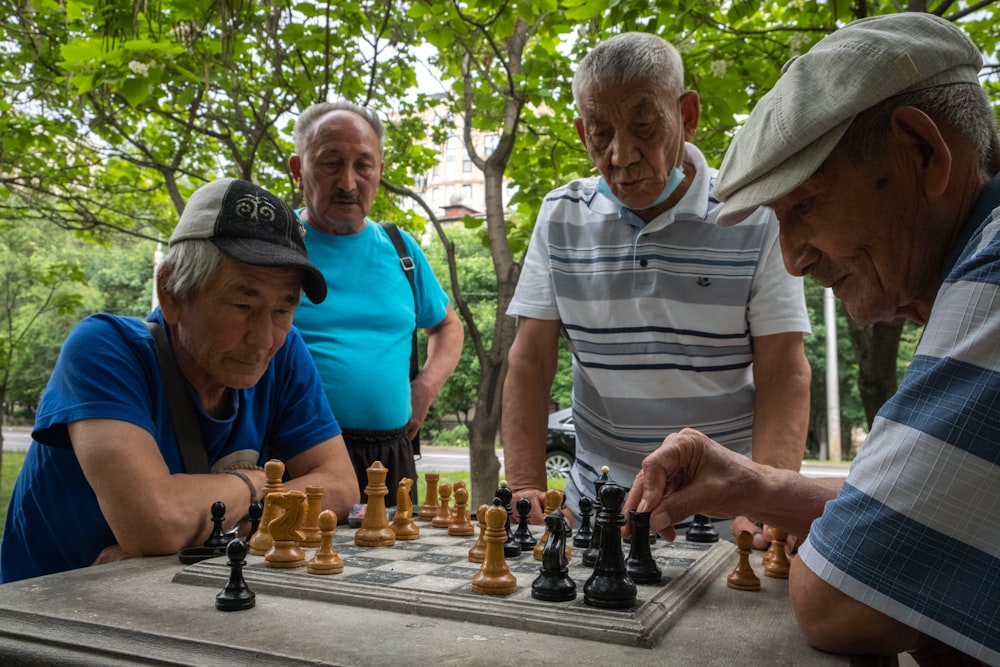 a group of older men playing a game of chess