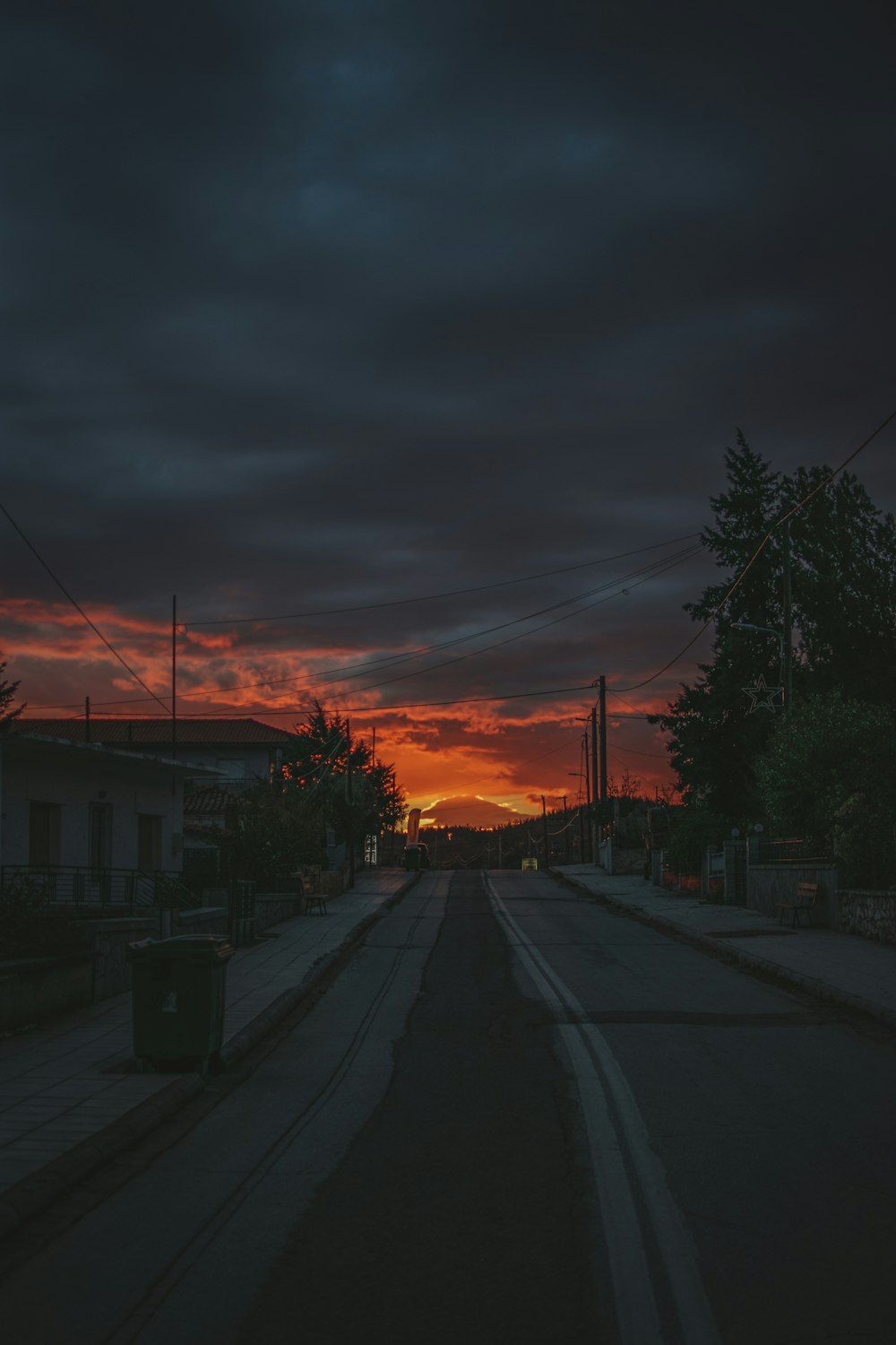 the sun is setting over a city street