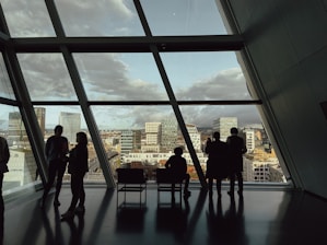 a group of people standing in front of a window