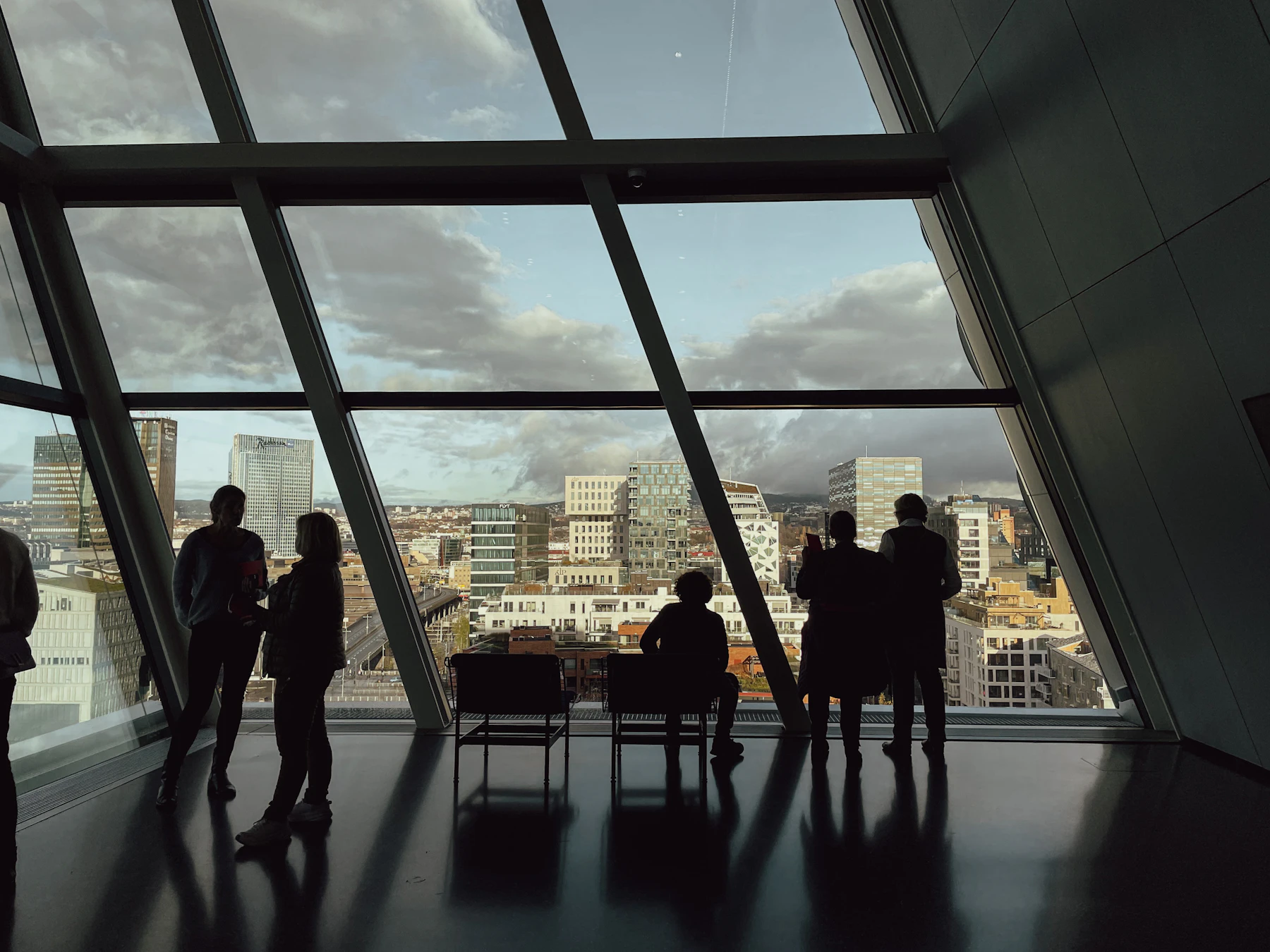 A group of people standing at a large window