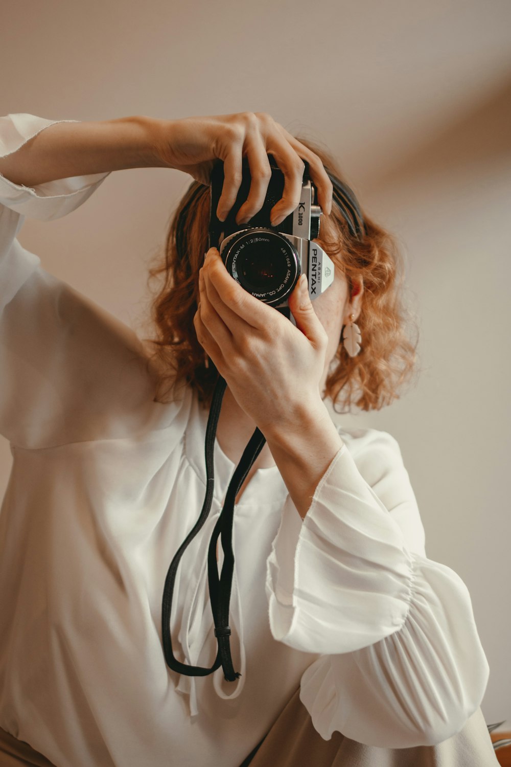 a woman taking a picture of herself with a camera