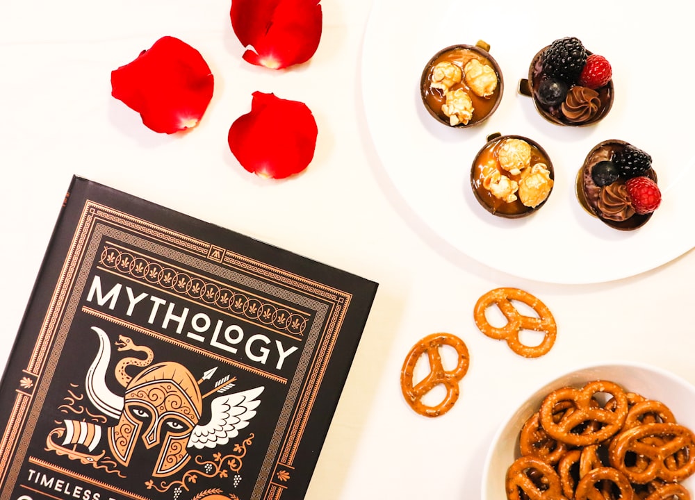 a book and a plate of pretzels on a table