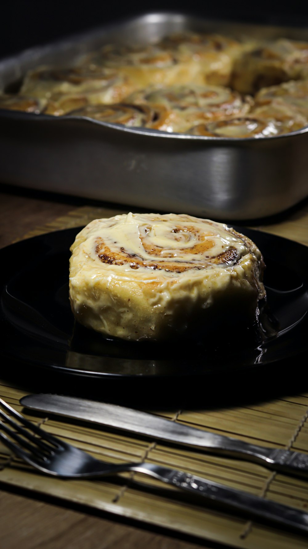 a plate with a pastry on it next to a pan of food