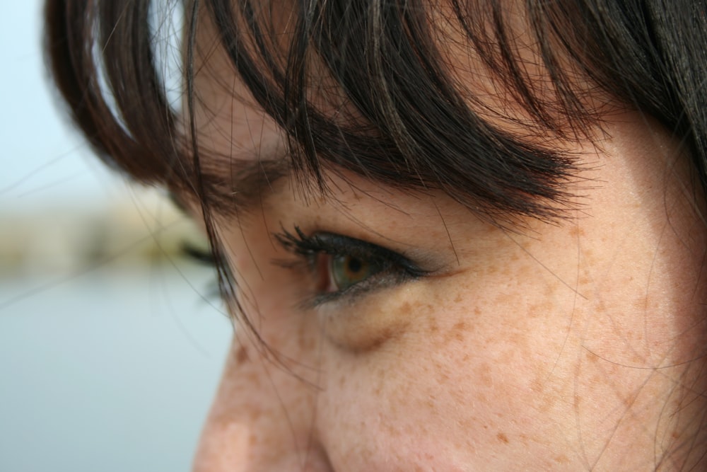 a close up of a person with freckled hair