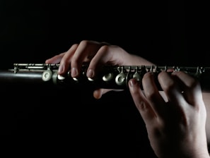 a person playing a flute in the dark
