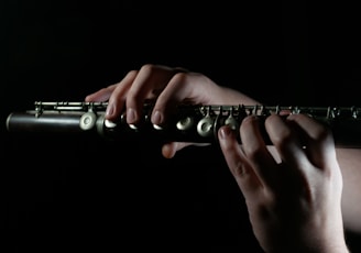 a person playing a flute in the dark