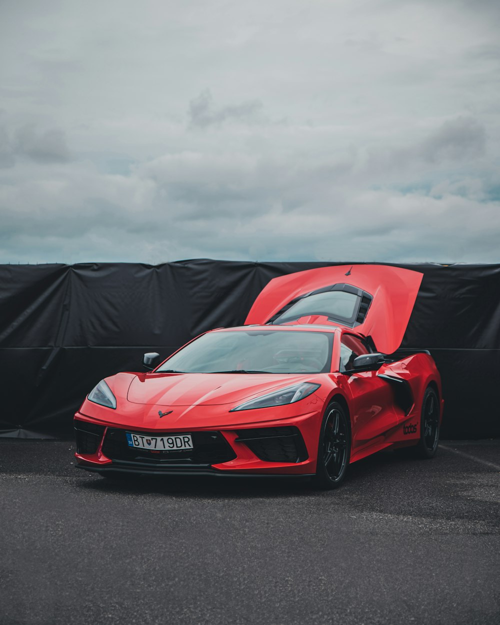 a red sports car parked in a parking lot