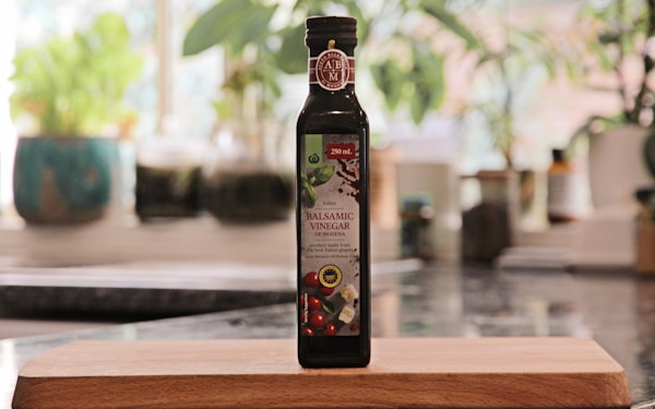 A bottle of extra virgin olive oil sitting on a cutting board