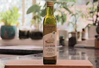 a bottle of garlic oil sitting on top of a counter