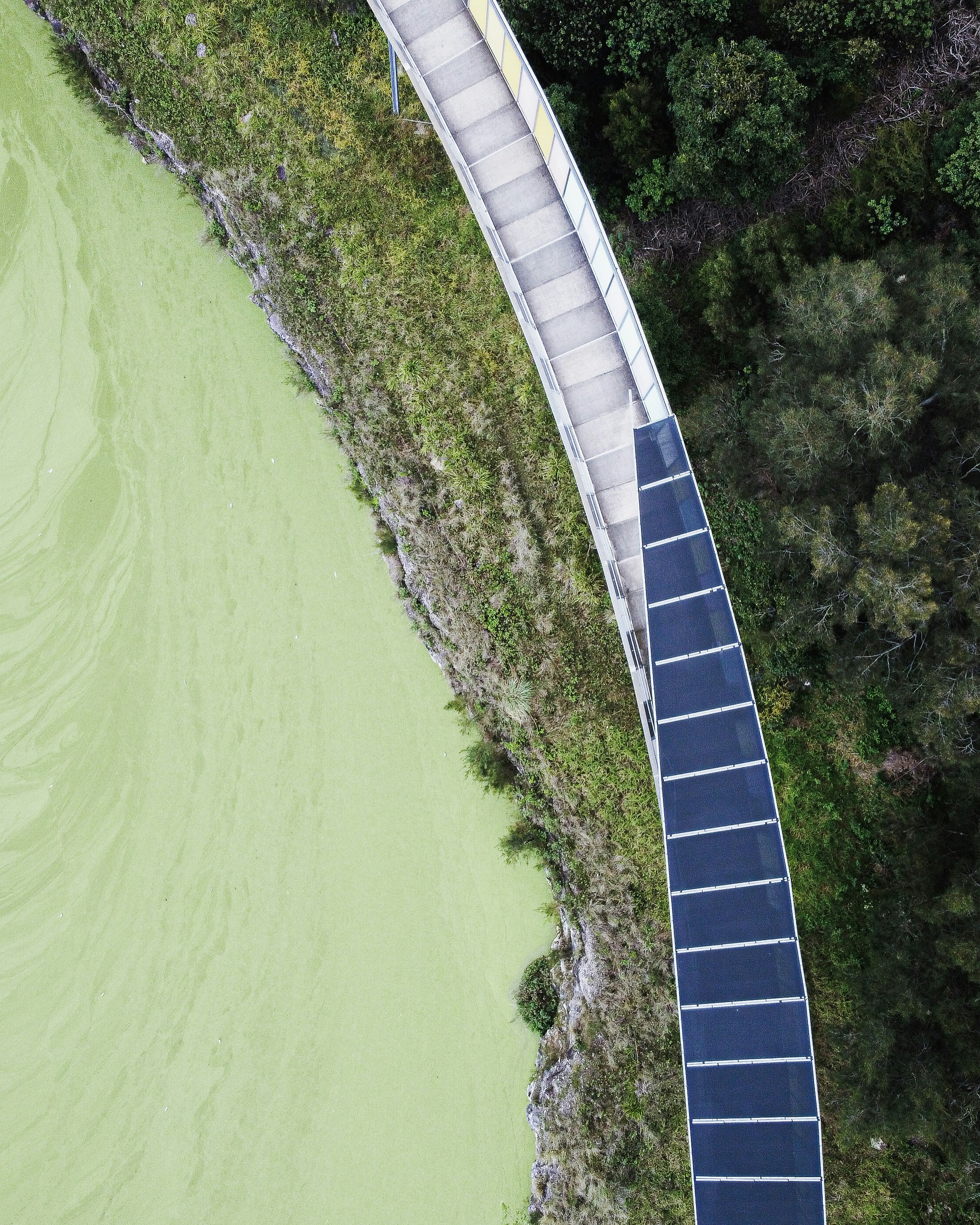 an aerial view of a walkway over a body of water