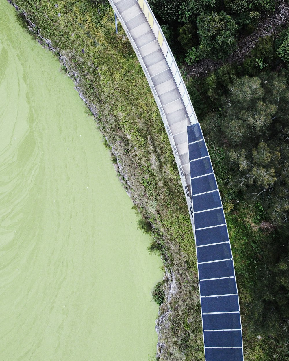 an aerial view of a walkway over a body of water