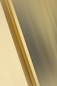 Abstract geometric shapes in muted gold and dark gray overlaying a blurred car dashboard.