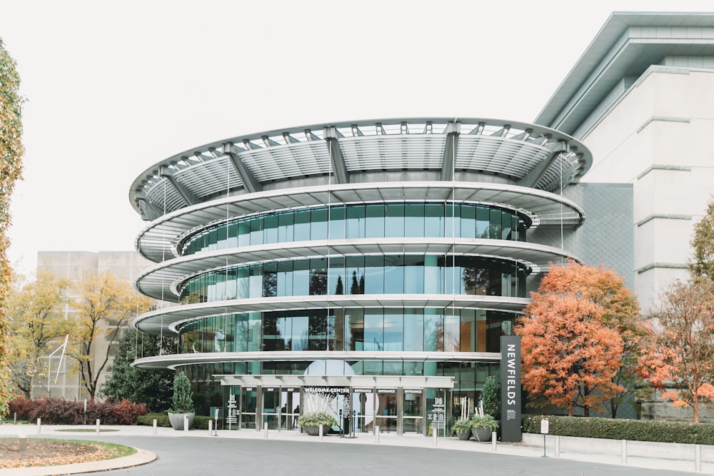 a large building with a circular entrance and trees in front of it