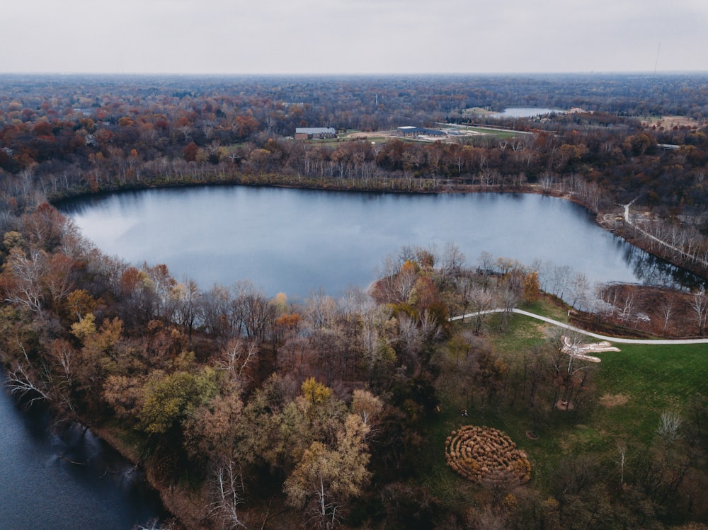 an aerial view of a lake surrounded by trees