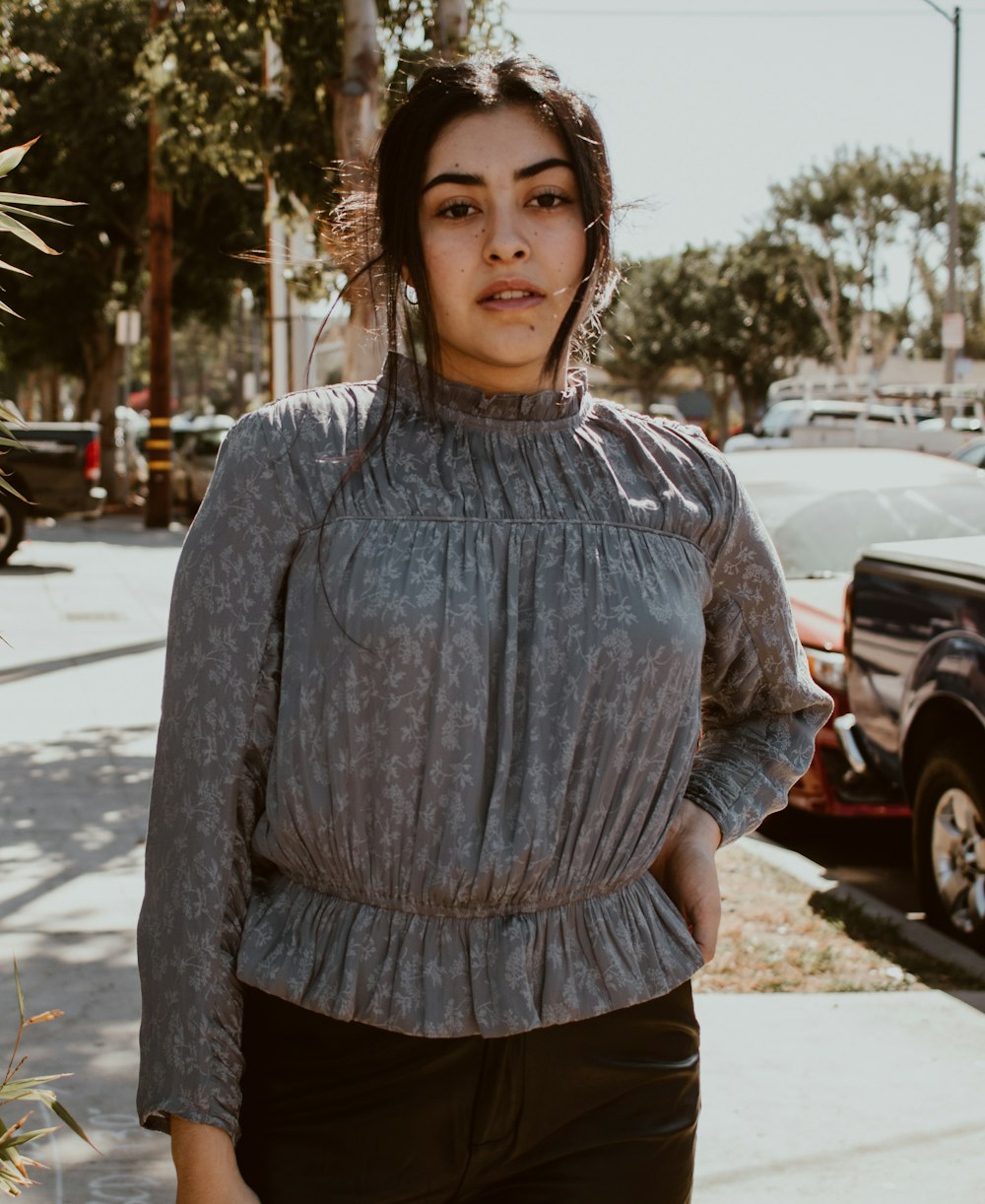 a woman standing on the side of a road