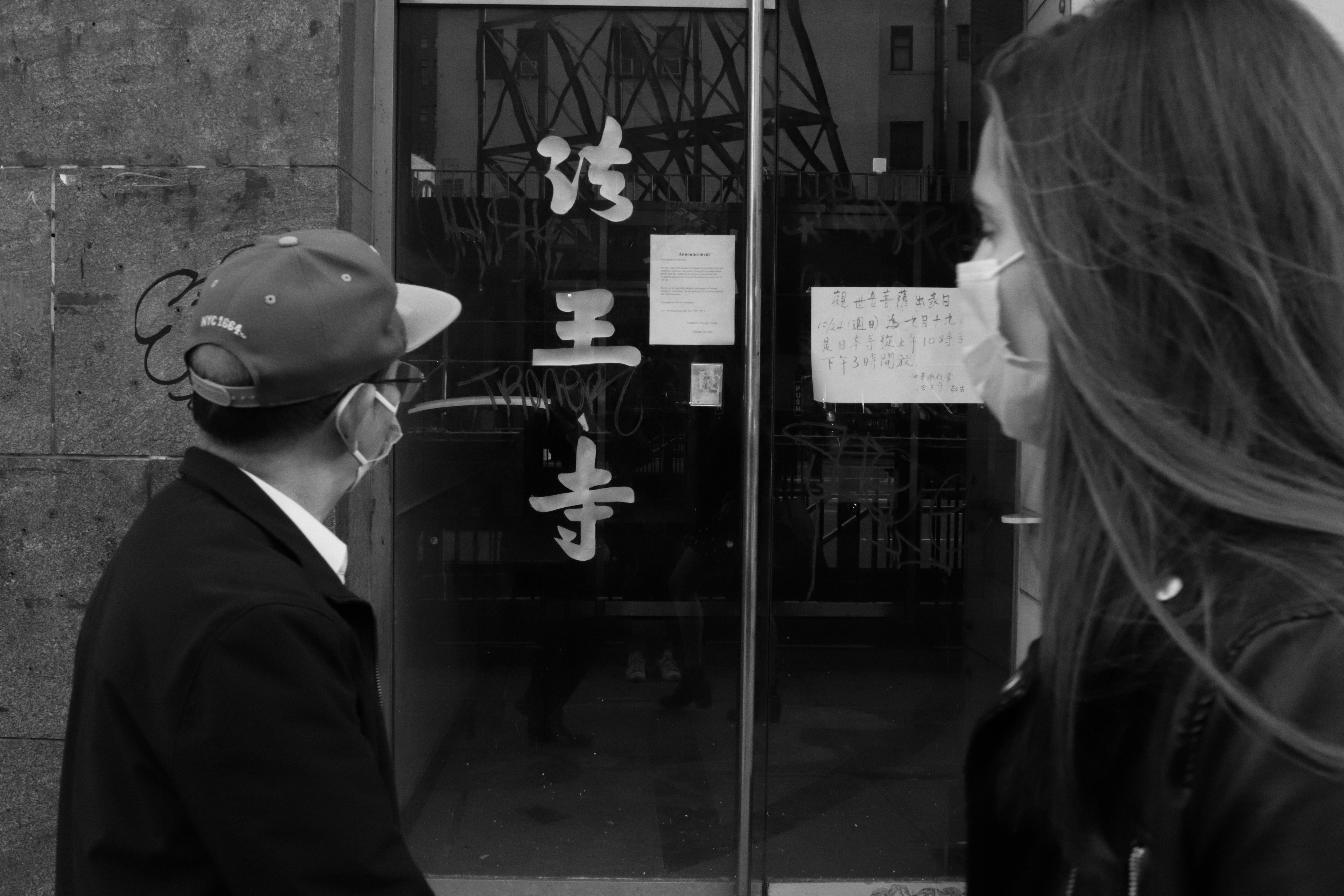 a man and a woman standing in front of a building