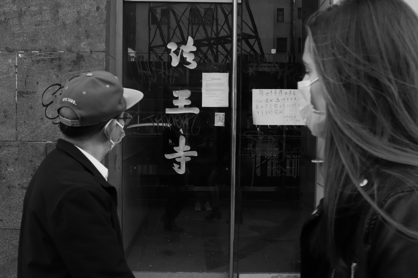 a man and a woman standing in front of a building