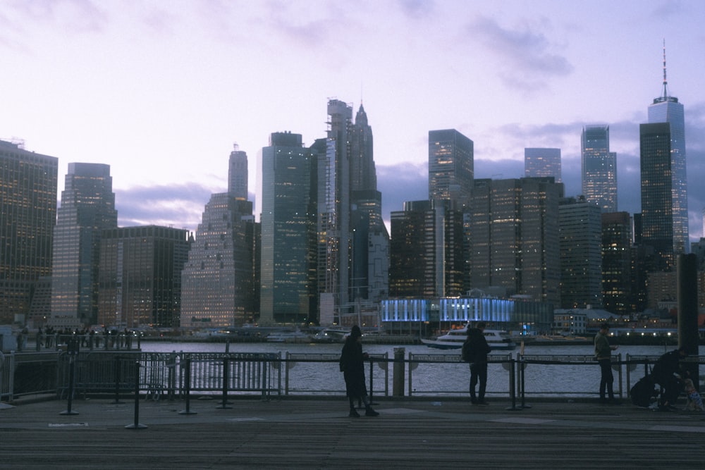 a group of people standing on top of a pier