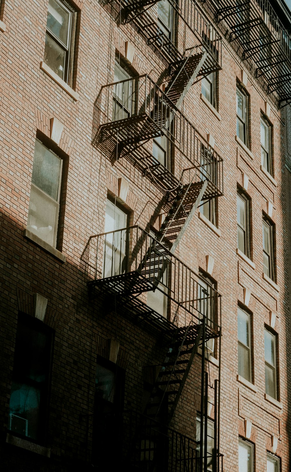 a fire escape next to a tall brick building