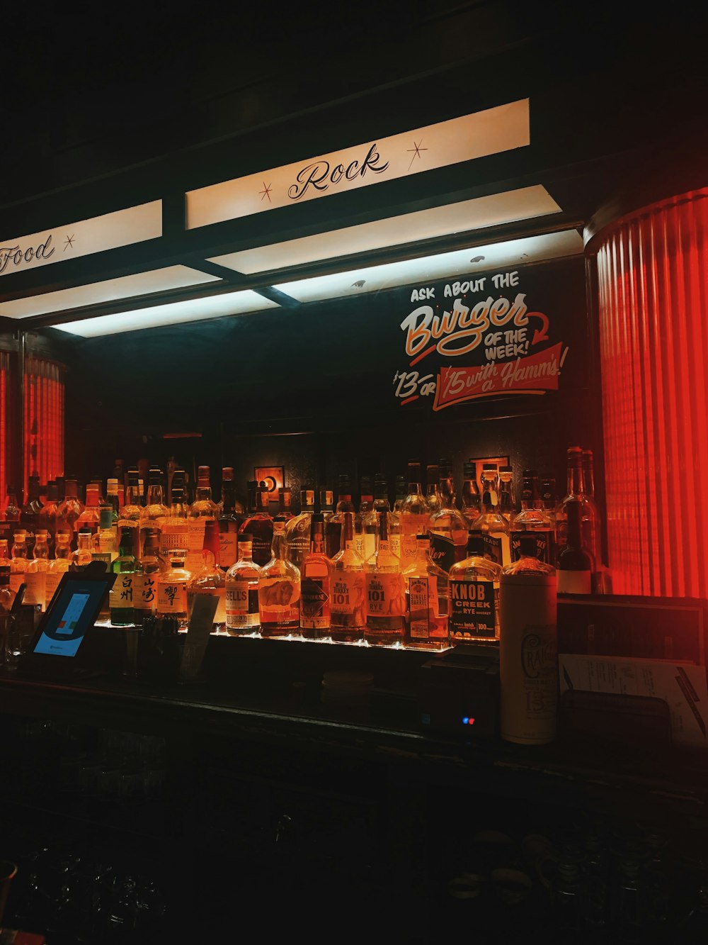 a bar with a lot of bottles of alcohol