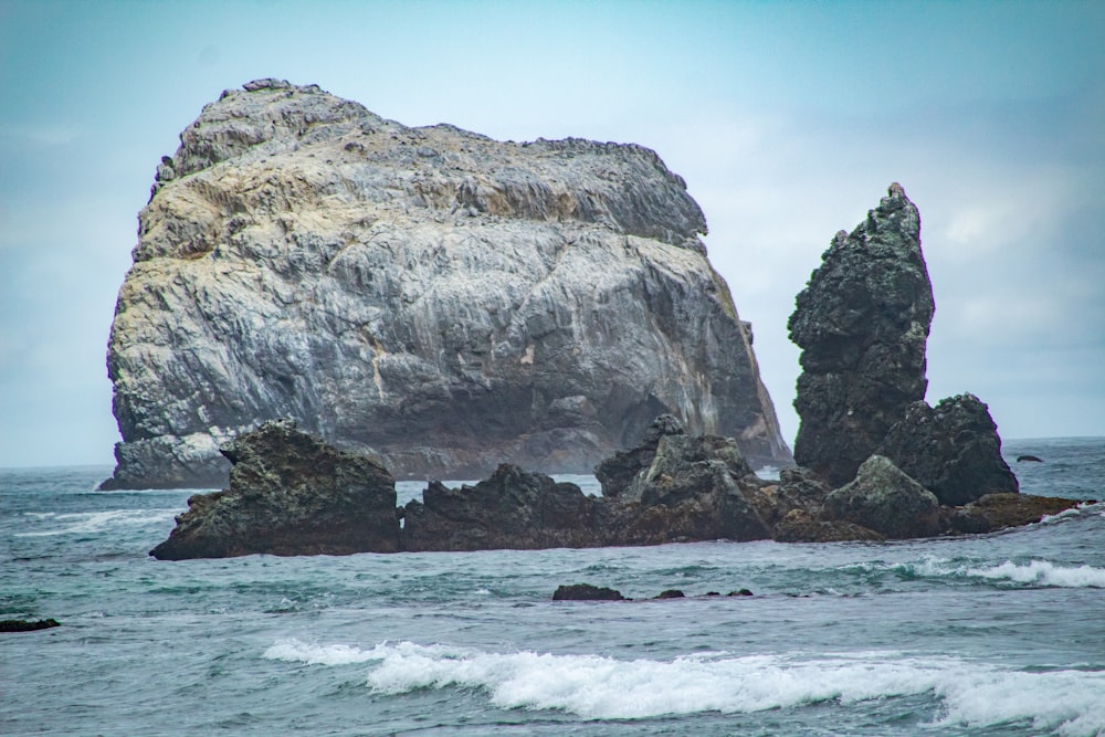 a large rock sticking out of the ocean