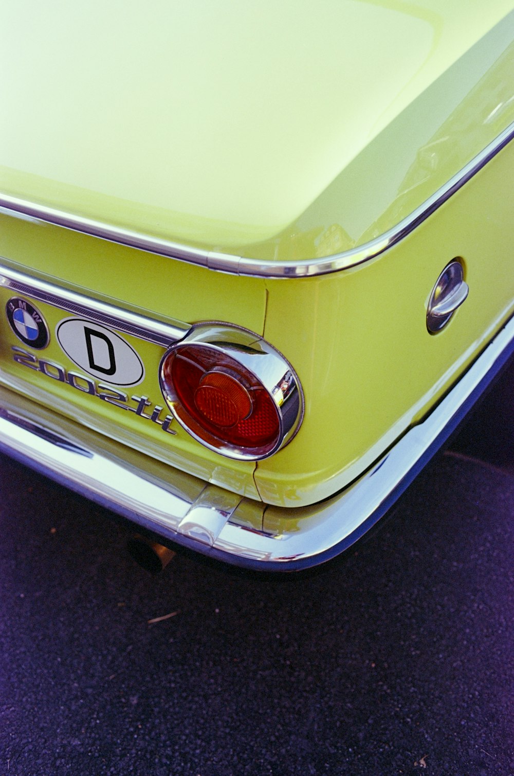 a close up of the tail end of a yellow car