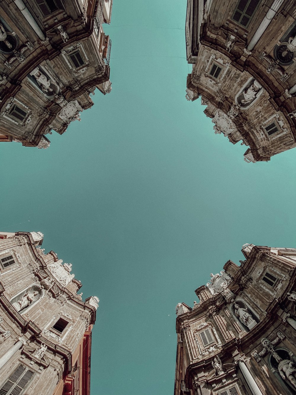 a group of buildings with a blue sky in the background