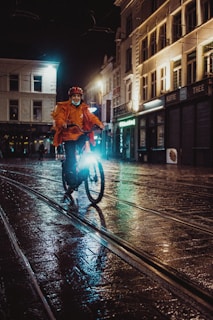 Evening shot of a reflective jacket catching the city lights with rain droplets.