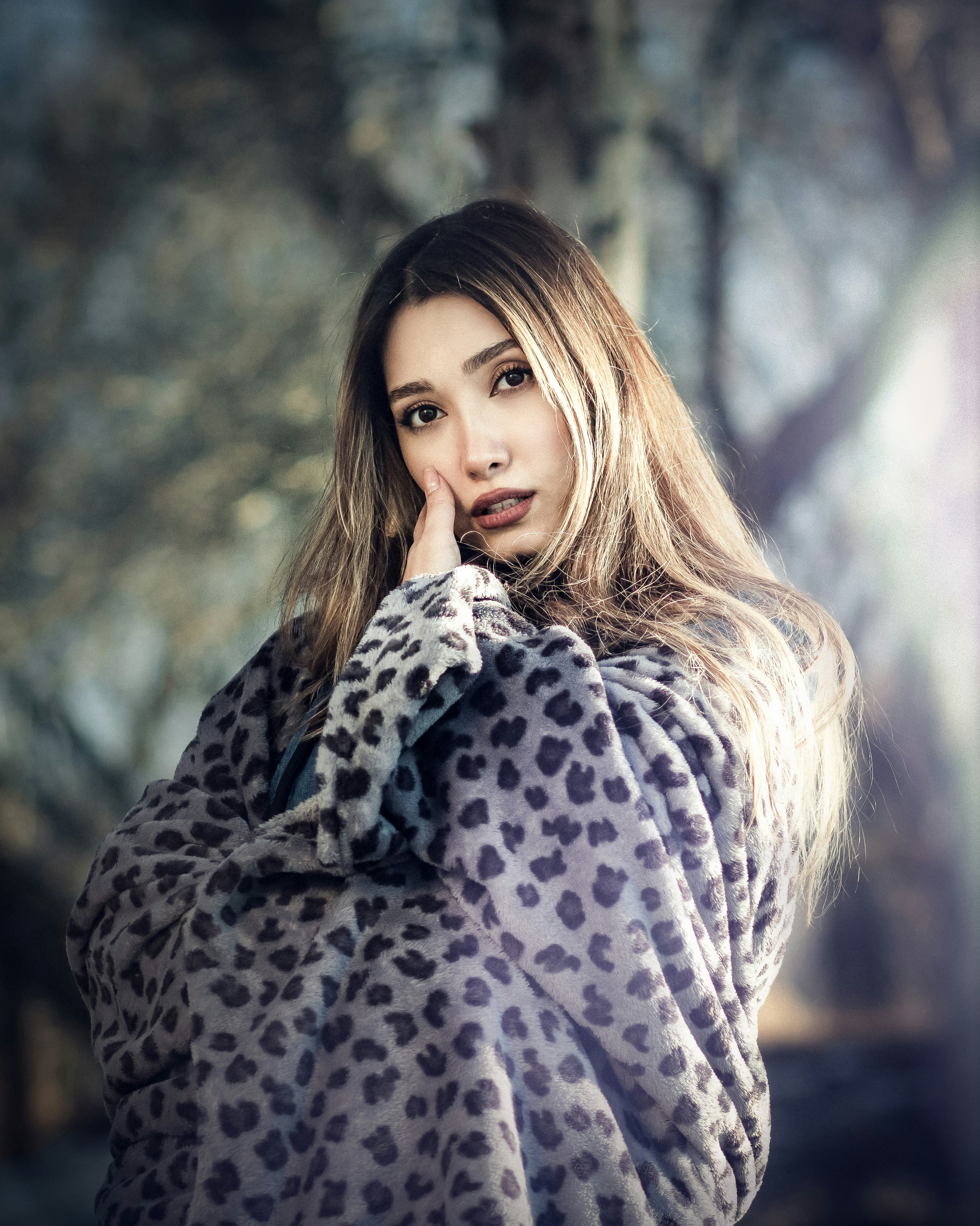 a woman in a leopard print blanket posing for a picture