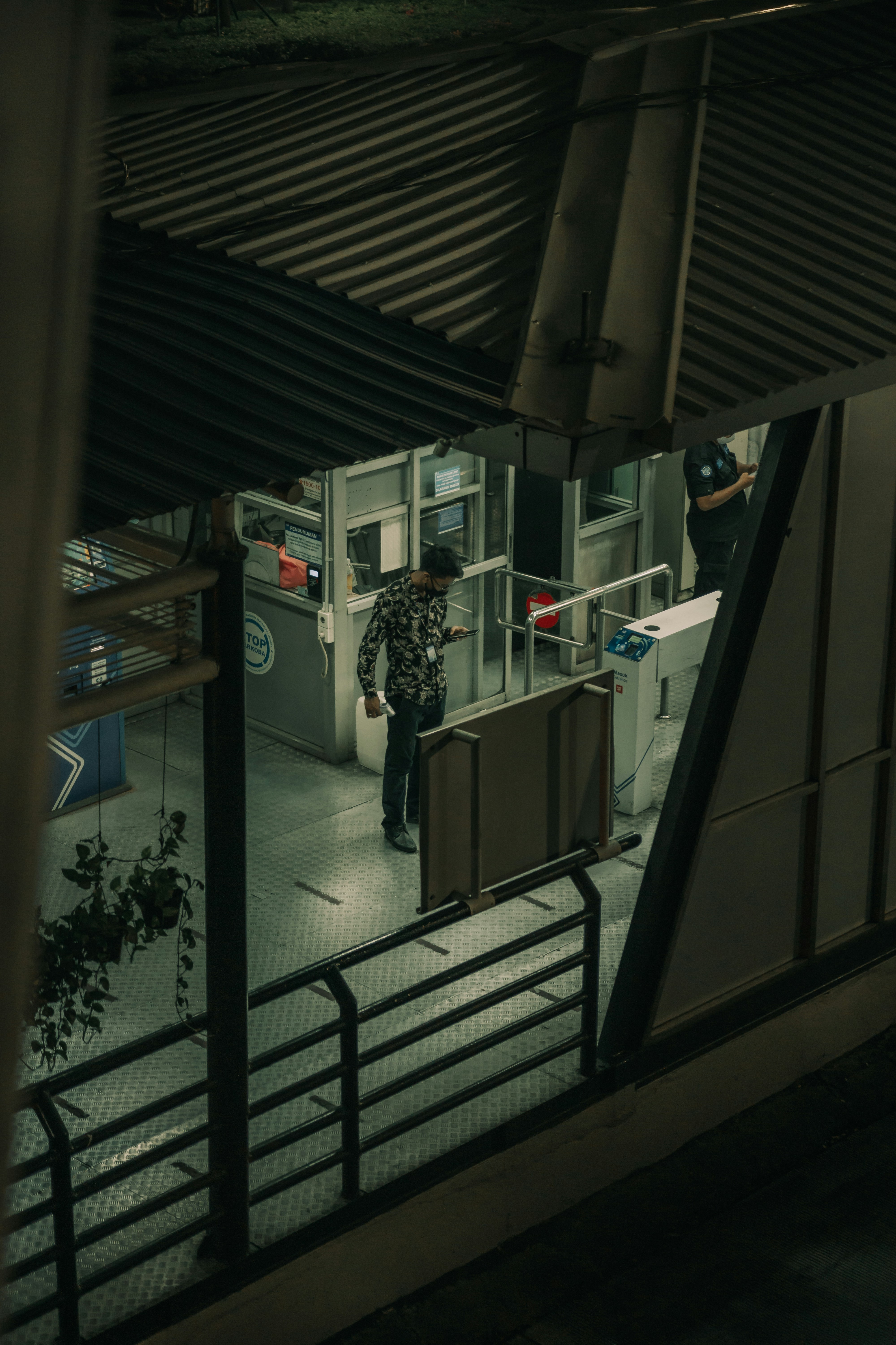 a man standing at a counter in a train station