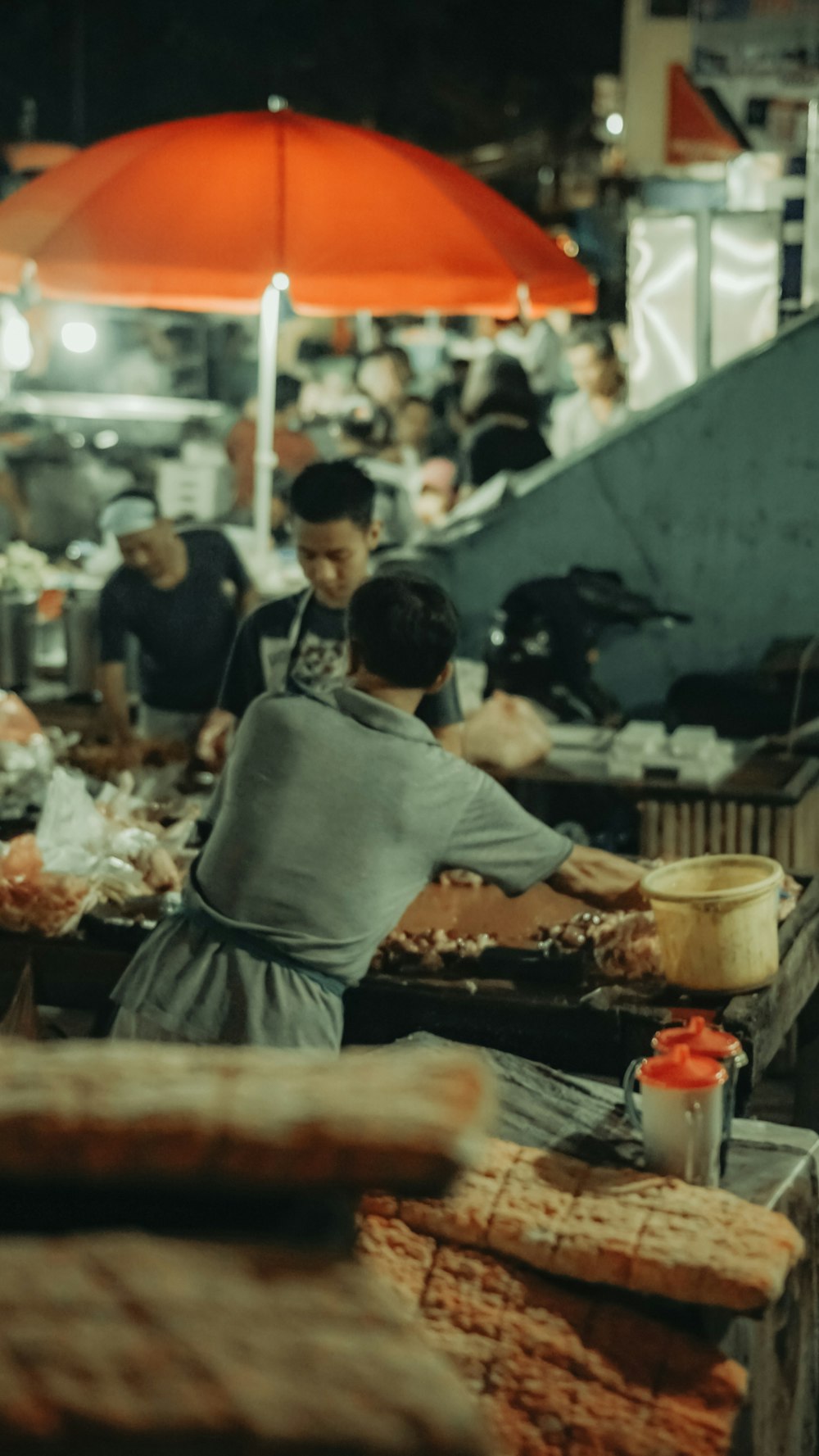 a group of people standing around a food market