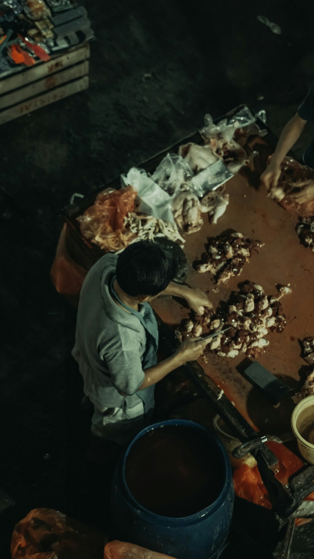 a man standing over a table filled with food