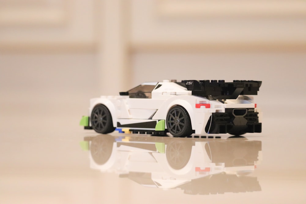 a white toy car sitting on top of a table