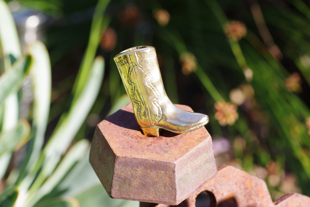 a pair of boots sitting on top of a piece of metal