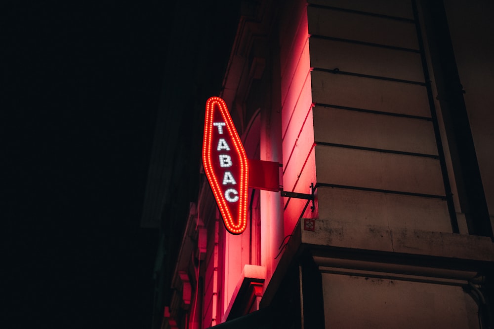 a neon sign on the side of a building