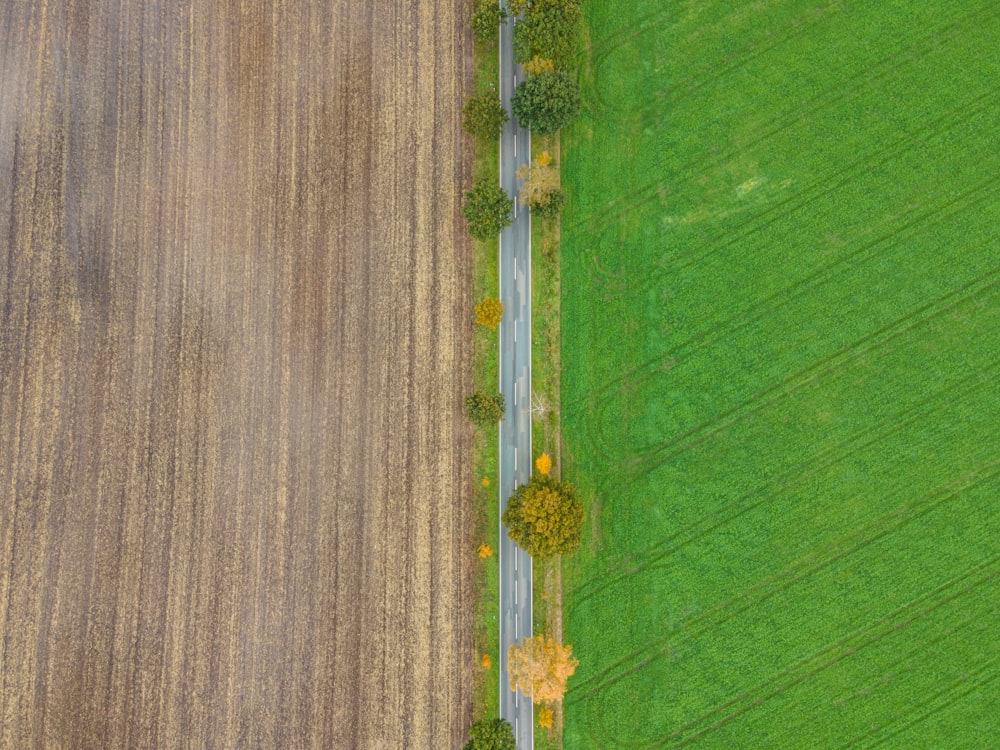 an aerial view of a road in the middle of a field